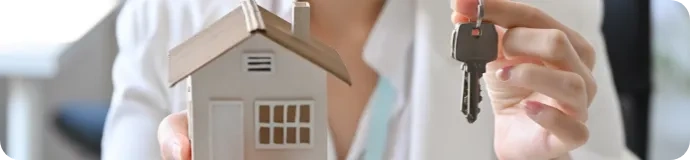 person holding an house and a key